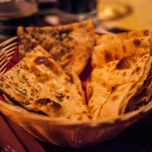 Close-up of traditional Indian flatbreads in a basket, perfect for a delicious meal.