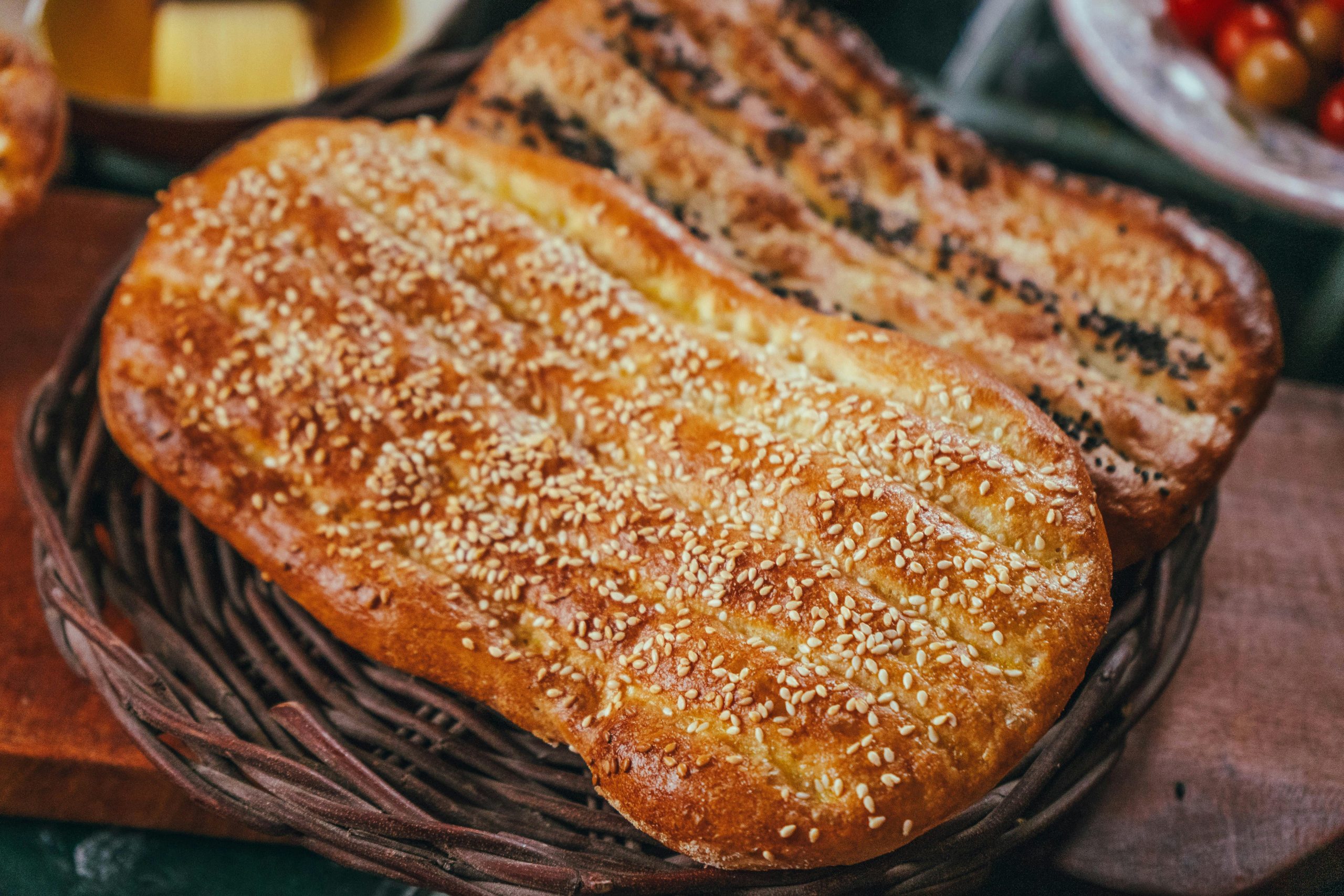 Delicious flatbreads topped with sesame and nigella seeds in a wicker basket.