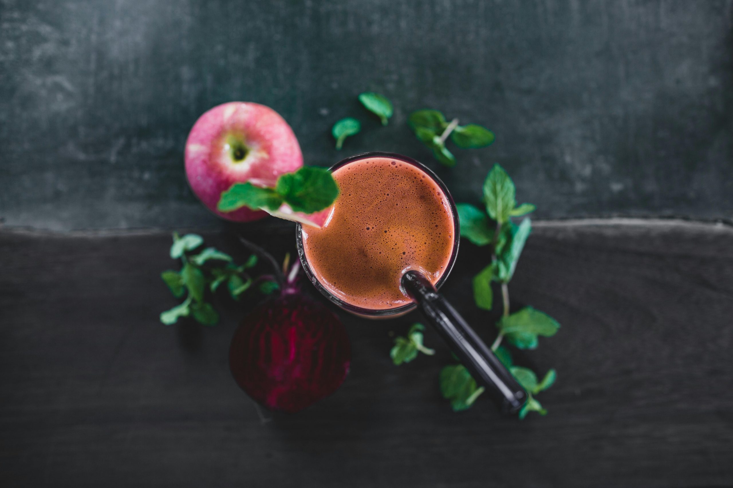 A top-down view of a healthy apple beetroot smoothie garnished with mint leaves, perfect for detox and refreshment.